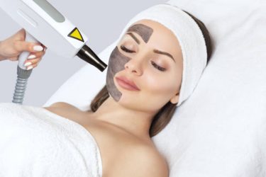 Carbon face peeling procedure in a beauty salon. Hardware cosmetology treatment.